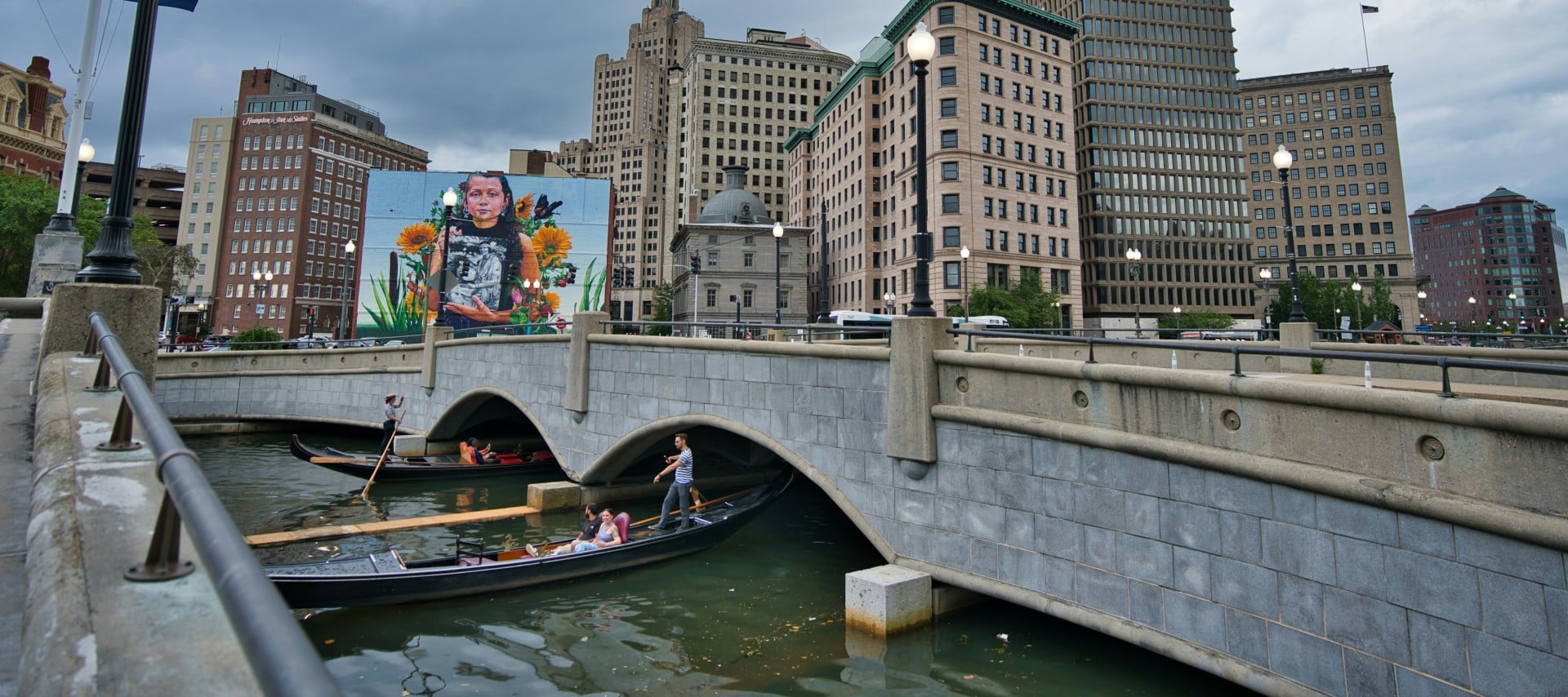 a gondola on the river with a city background