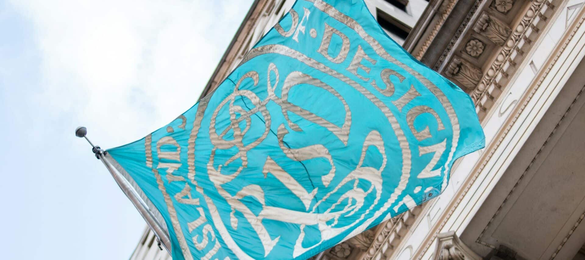 Teal and white flag with the lettering, RISD.